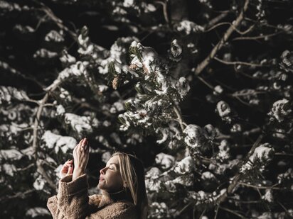 Person beim Meditieren im Winter bei Nacht im Außenbereich des Engels