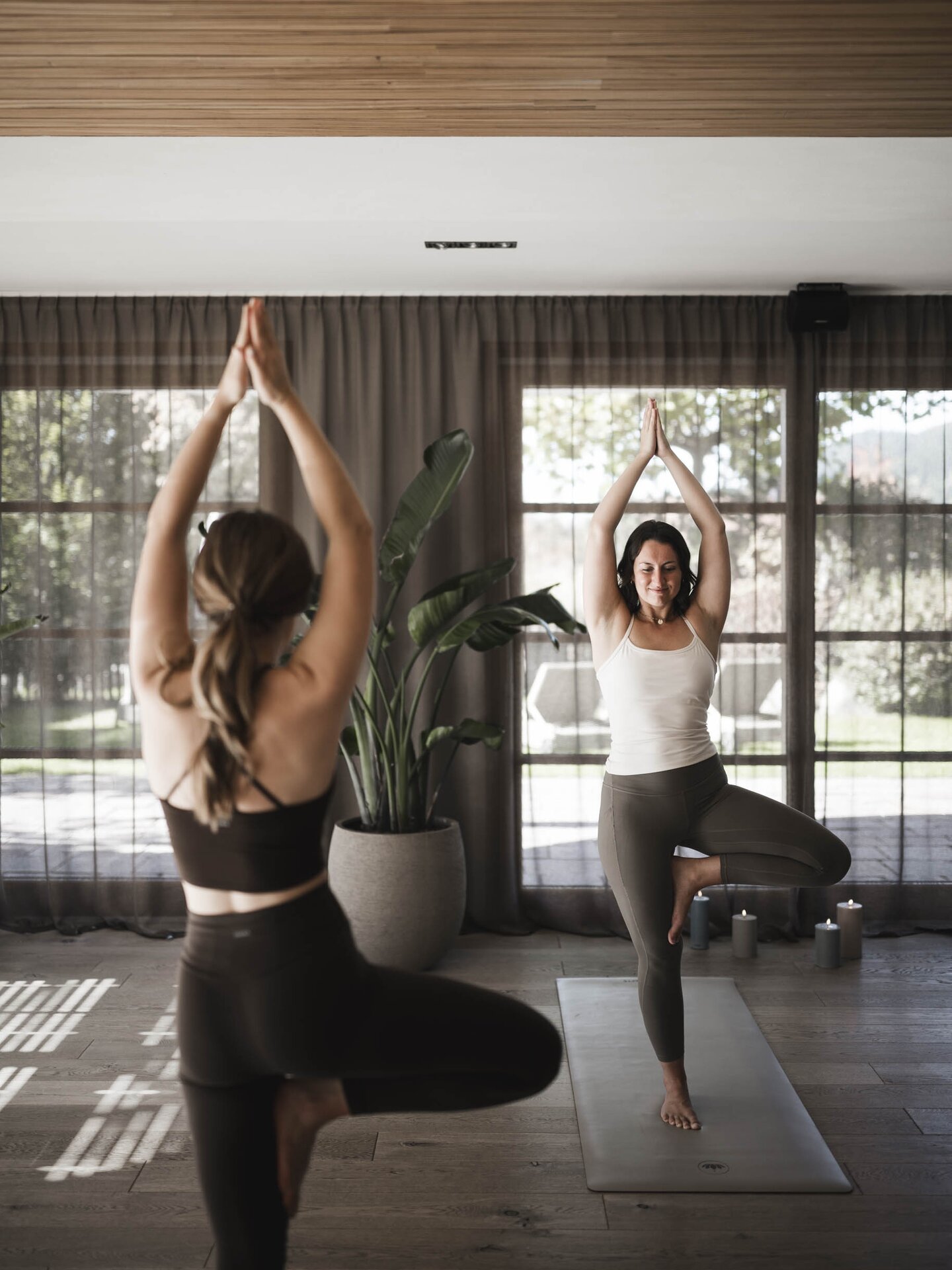 Two people during a yoga session in the yoga room at Wellnesshotel Der Engel